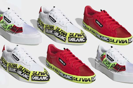 Six adidas x Olivia OBlanc trainers in white and red, each with a yellow tape midsole printed with the OLIVIA OBLANC name