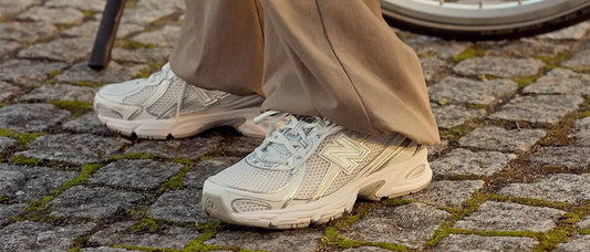 woman wearing white new balance trainers on cobbled ground